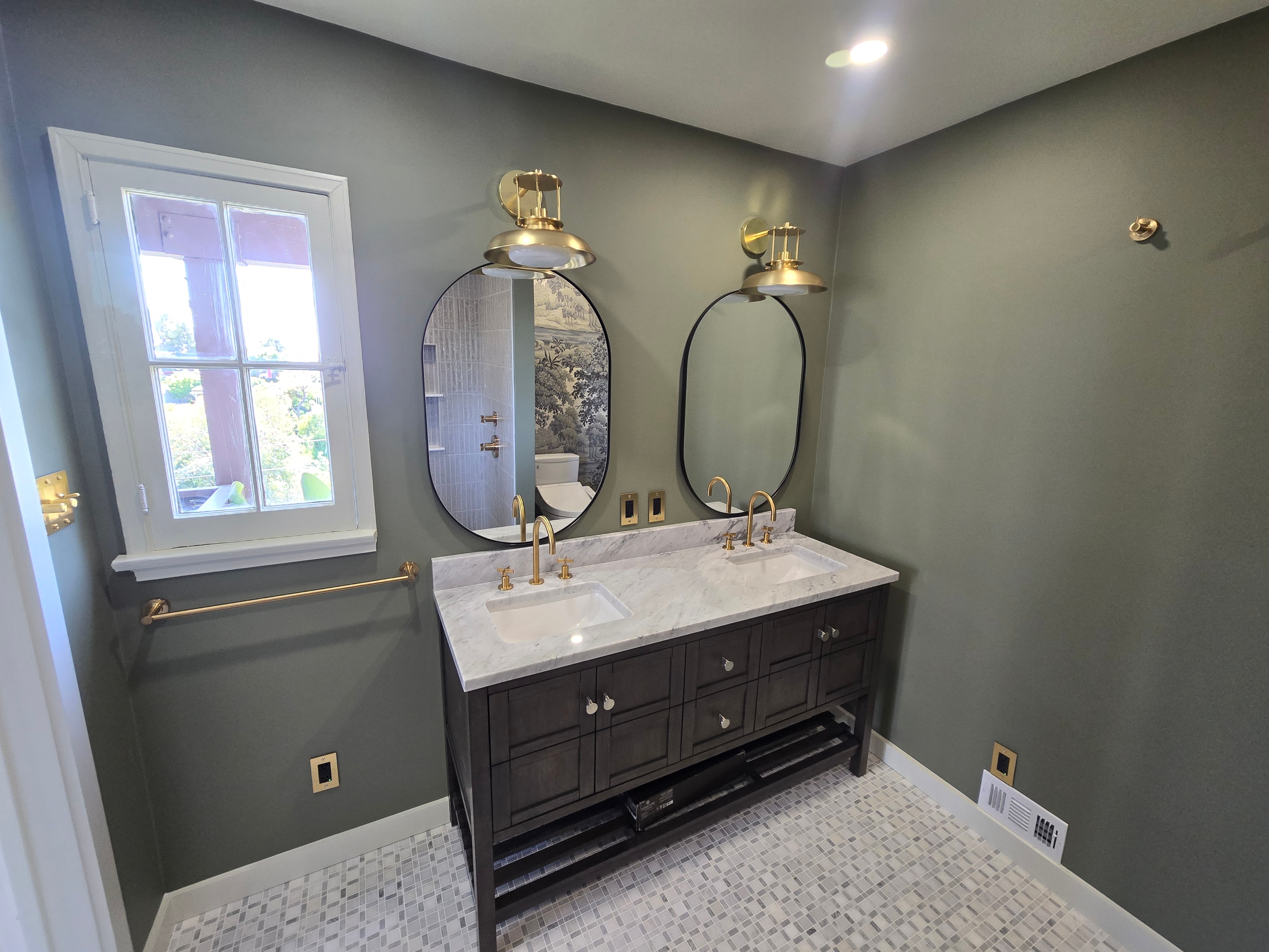 Bathroom remodel — full room view with double vanity and mosaic tile floor