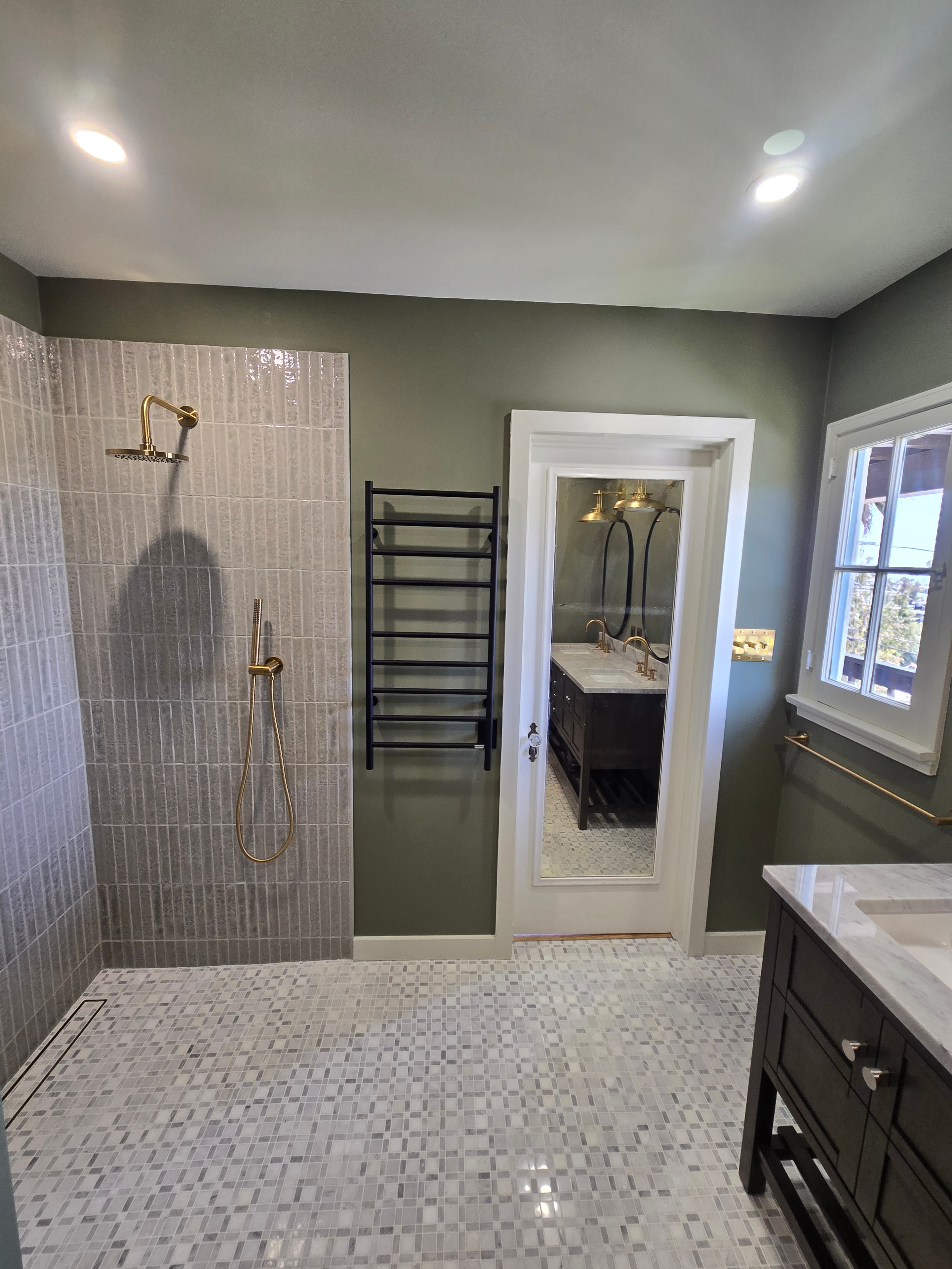 Bathroom remodel — walk-in shower with skylight and brass fixtures